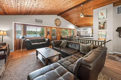 a living room with a couch and a table at Lakefront the Cove - On the Lake in Big Bear Lake