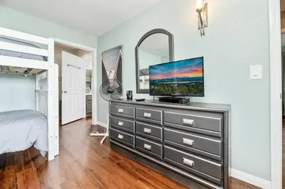 a bedroom with a dresser with a flat screen tv on it at Lakefront the Cove - On the Lake in Big Bear Lake