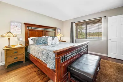 a bedroom with a large bed and a window at Lakefront the Cove - On the Lake in Big Bear Lake