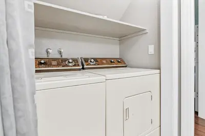 a laundry room with two sinks and a mirror at Lakefront the Cove - On the Lake in Big Bear Lake
