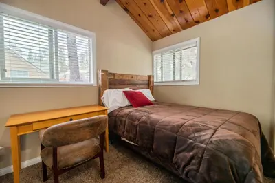 a bedroom with a bed and a desk and a chair at Lakeview Trout N About - Walk to Lake, Close to Village & Slopes in Big Bear Lake