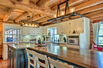 a large kitchen with a large counter top in a house at Pine Mountain Club Log Home with Deck and Grill! in Pine Mountain Club