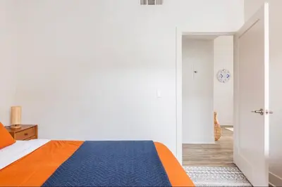 a white bedroom with a blue and orange bed at Tulum Vibes 1 Bedroom Apartment near Boats in Marina Del Rey in Los Angeles