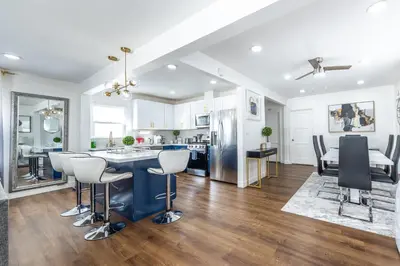 a kitchen and living room with a table and chairs at Luxury Villa with Hot Tub! Minutes to Beach & Bars in Long Beach