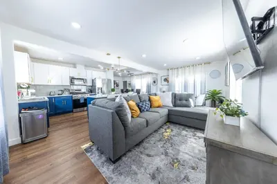 a living room with a couch and a kitchen at Luxury Villa with Hot Tub! Minutes to Beach & Bars in Long Beach