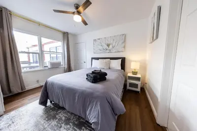 a bedroom with a bed with a suitcase on it at Luxury Villa with Hot Tub! Minutes to Beach & Bars in Long Beach