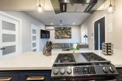 a kitchen with a stove top oven in a room at Fam Friendly 2BD 8min from airport, 4min from SoFi in Los Angeles