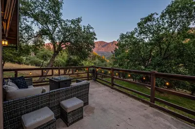 an outdoor patio with a view of the mountains at Hygge Haus Sequoia - Large Private Cabin w Views in Ponderosa