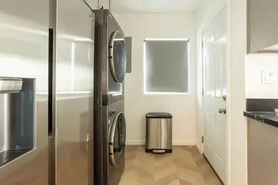 a kitchen with a refrigerator and a trash can at Coziest 1BD Bungalow 8min from airport, 4 min SoFi in Los Angeles