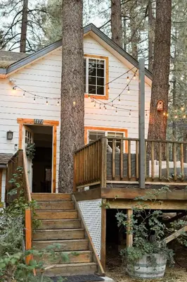 a house with a deck and a tree at Aery Pines in Wrightwood
