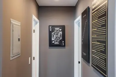 a hallway with three pictures on the wall at Newly Renovated Bungalow w Free Parking 4min from SoFi, 8min from Airport in Los Angeles
