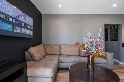 a living room with a couch and a table at Newly Renovated Bungalow w Free Parking 4min from SoFi, 8min from Airport in Los Angeles