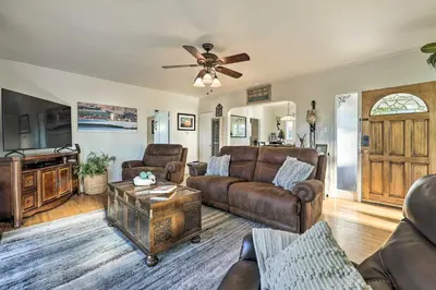 a living room with leather furniture and a ceiling fan at Walk to Ventura Beach Comfy Home with Ocean Views in Ventura