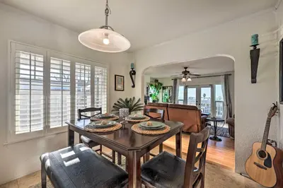 a dining room with a table and chairs and a guitar at Walk to Ventura Beach Comfy Home with Ocean Views in Ventura