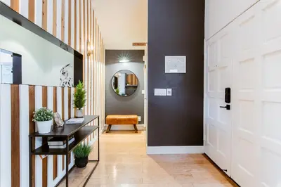 a hallway with a door and a table with plants at Modern Treetop Cabin by Lake Arrowhead Village in Lake Arrowhead