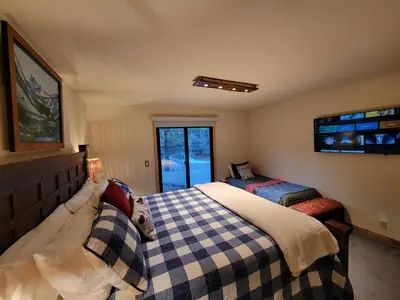 a bedroom with a bed and a window at Four Seasons Getaway-Private Hot Spa with Pine Tree Views-Walk to Village and Pineknot Trailhead-Plus King Bed! in Big Bear Lake