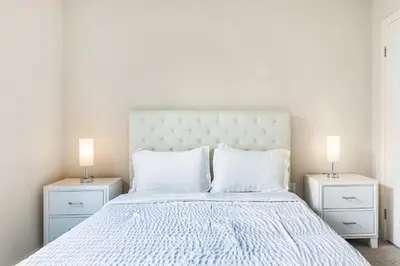 a bedroom with a white bed with two night stands at Luxury 2 Bedroom 2 Bathroom With Fitness Center and Pool in Los Angeles