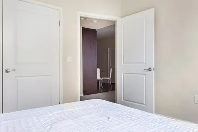 a bedroom with two doors and a bed in a room at Luxury 2 Bedroom 2 Bathroom With Fitness Center and Pool in Los Angeles
