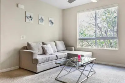 a living room with a couch and a glass table at Luxury 2 Bedroom 2 Bathroom With Fitness Center and Pool in Los Angeles