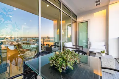 a balcony with a glass table and chairs at @ Marbella Lane - Aesthetic 2BR w/Ocean views in Long Beach