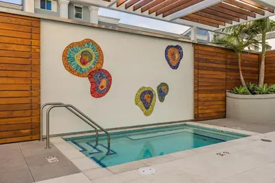 a swimming pool with art on the wall at @ Marbella Lane - Aesthetic 2BR w/Ocean views in Long Beach