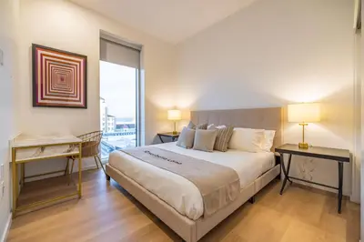 a bedroom with a large bed and a large window at @ Marbella Lane - Luxury Beachside 2BR in Long Beach