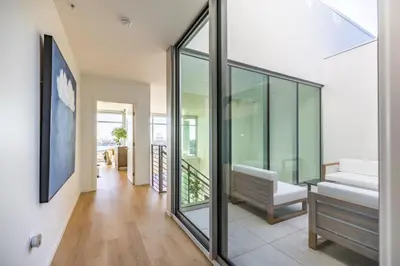 a living room with glass windows and a couch at @ Marbella Lane - Luxurious 3BR Penthouse in Long Beach