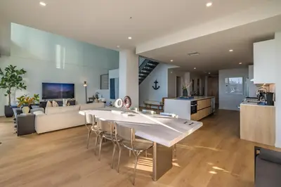 a kitchen and living room with a large table and chairs at @ Marbella Lane - Luxurious 3BR Penthouse in Long Beach