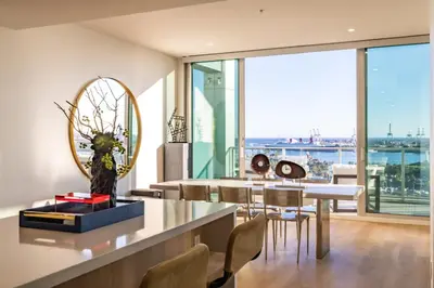 a dining room with a table and a mirror at @ Marbella Lane - Luxurious 3BR Penthouse in Long Beach