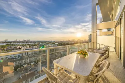 a balcony with a table and chairs on a building at @ Marbella Lane - Penthouse w/ City & Ocean Views in Long Beach