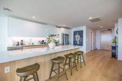 a kitchen with bar stools and a counter top at @ Marbella Lane - Penthouse w/ City & Ocean Views in Long Beach