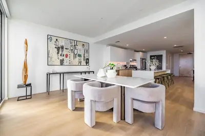 a white dining room with a white table and chairs at @ Marbella Lane - Penthouse w/ City & Ocean Views in Long Beach