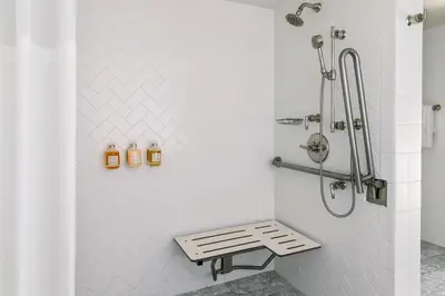 a shower stall with a bench in a bathroom at The Eden in Los Angeles