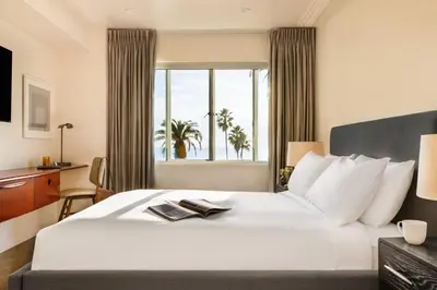 a bedroom with a large white bed with a window at The Eden in Los Angeles