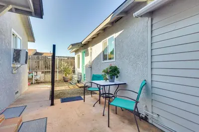 a patio with a table and chairs next to a building at Quiet Carpinteria Cottage By Town and Beaches in Carpinteria