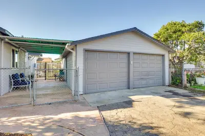 a garage with a fence and a house at Quiet Carpinteria Cottage By Town and Beaches in Carpinteria