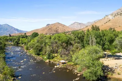 a river with trees and mountains in the background at Adorable little cabin #28 in Kernville