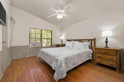 a bedroom with a bed and a ceiling fan at The Sequoia House in Kernville