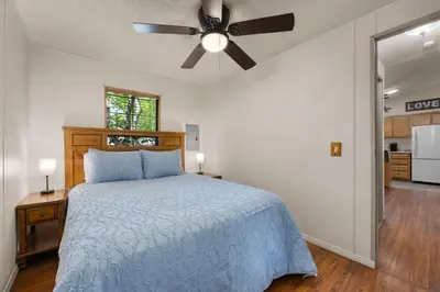 a bedroom with a bed and a ceiling fan at The Sequoia House in Kernville