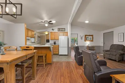 a kitchen and living room with a table and chairs at The Sequoia House in Kernville