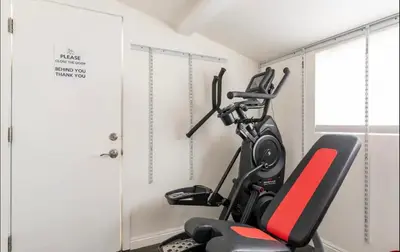 a room with a gym with two tread machines at Gorgeous DTLA w/ View + Hot Tub! in Los Angeles