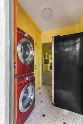 a washer and dryer in a kitchen with a black door at The Spanish Hideaway in Los Angeles