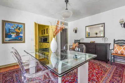 a dining room with a glass table and chairs at The Spanish Hideaway in Los Angeles