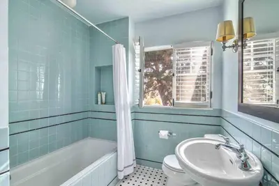 a bathroom with a sink and a tub and a toilet at The Spanish Hideaway in Los Angeles
