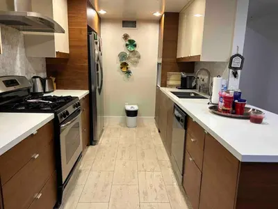 a kitchen with wooden cabinets and a stove top oven at Glendale Americana 2 Bedroom 2 Bathroom Condo in Glendale