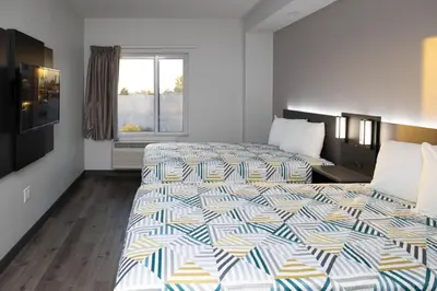 a hotel room with two beds and a window at Motel 6 Highland CA San Bernardino East in Highland