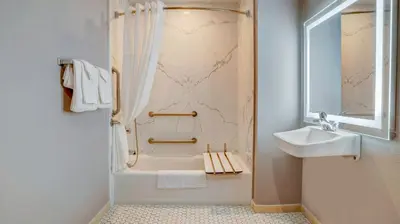 a white bathroom with a shower and a sink at Motel 6 Highland CA San Bernardino East in Highland
