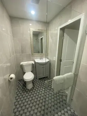 a bathroom with a toilet and a sink and a shower at City Center Motel - Oxnard in Oxnard