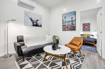a living room with a couch and a table and a bed at Magnolia Apt in Los Angeles