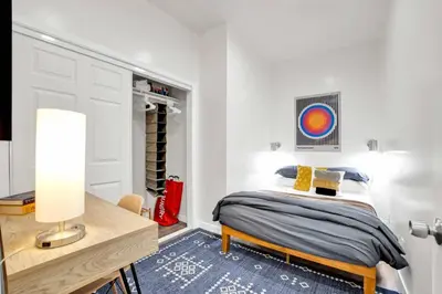 a bedroom with a bed and a desk with a lamp at Magnolia Apt in Los Angeles